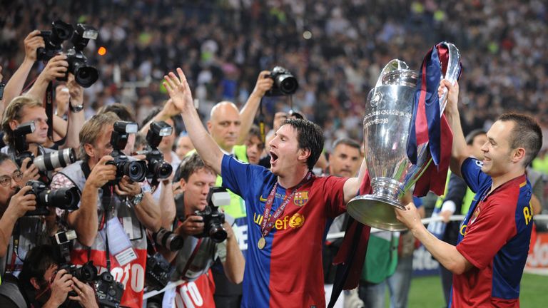 Barcelona?s Argentinian forward Lionel Messi (C) and Barcelona?s midfielder Andres Iniesta (R) celebrate with the Champions League Cup afte the trophy cere