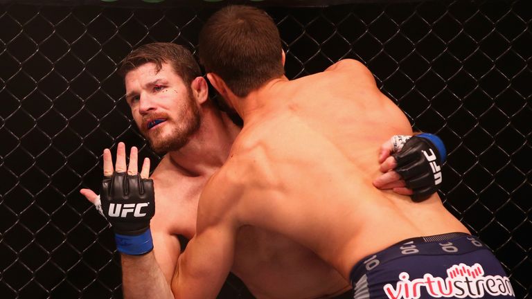 Michael Bisping appeals to the referee after being cut above the eye by Luke Rockhold in their middleweight fight during 