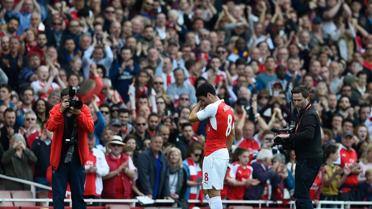 Mikel Arteta of Arsenal shows his emotion as supporters applaud after the Barclays Premier League match between Arsenal an