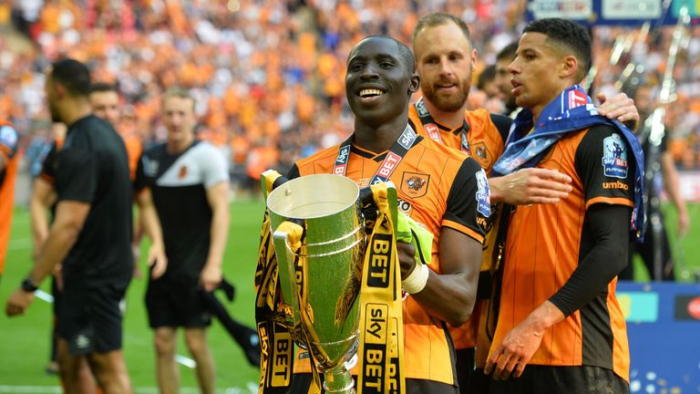 Hull City hero Mohamed Diame lifts the trophy after scoring the goal that fired his side back to the Premier League