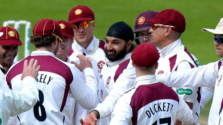 NORTHAMPTON, ENGLAND - MAY 15: Monty Panesar of Northamptonshire celebrates taking the wicket of  Sam Northeast of Kent during day one of the Specsavers Co