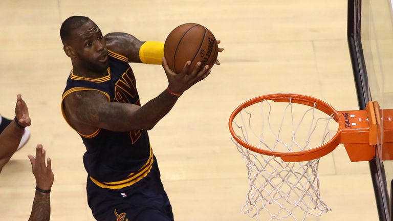 LeBron James #23 of the Cleveland Cavaliers lays the ball up against the Toronto Raptors