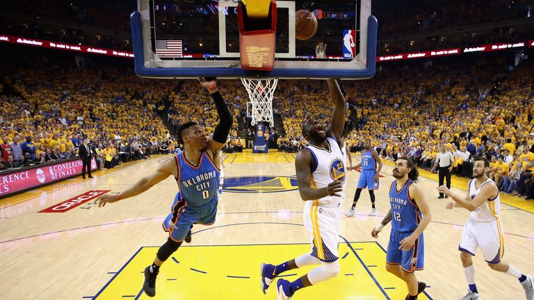 Draymond Green of the Golden State Warriors lays one up against Russell Westbrook of the Oklahoma City Thunder 