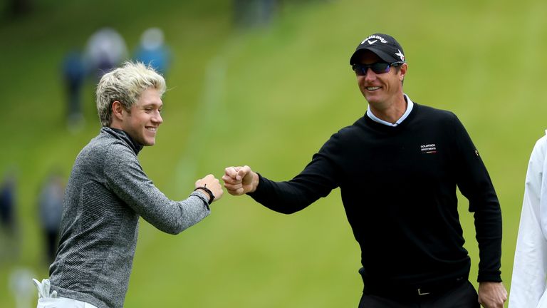 Niall Horan celebrates with Nicolas Colsaerts of Belgium during the Pro-Am prior to the BMW PGA Championship at Wentworth