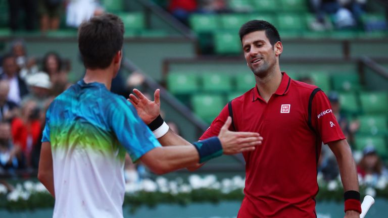 Novak Djokovic shakes hands with Aljaz Bedene