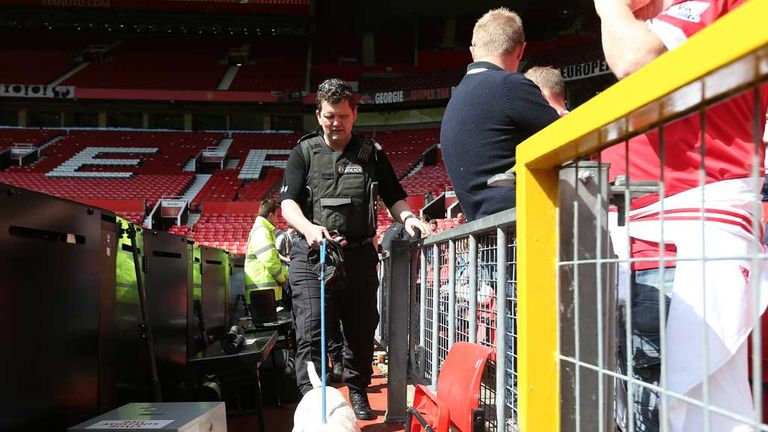 A police sniffer dog at Old Trafford after the match was called off  