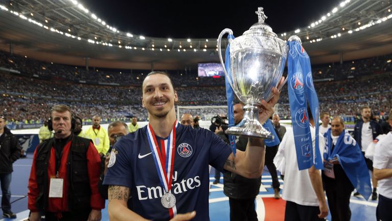 Paris-Saint-Germains Swedish forward Zlatan Ibrahimovic holds up the trophy after winning the French Cup final football match against Auxerre at the Stade 