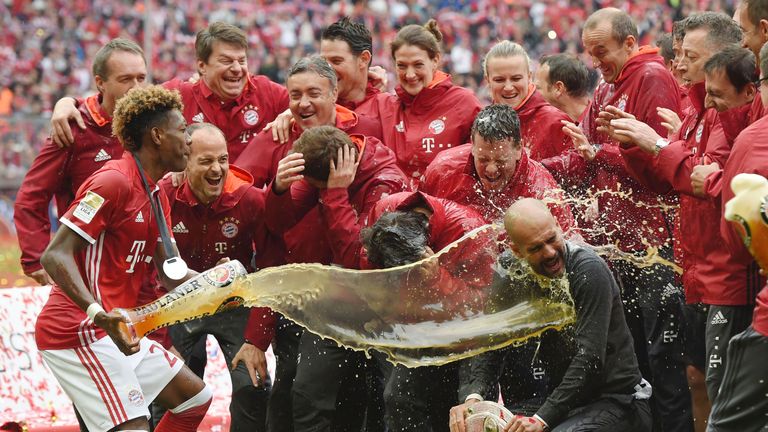 Pep Guardiola  is doused in beer by David Alaba.