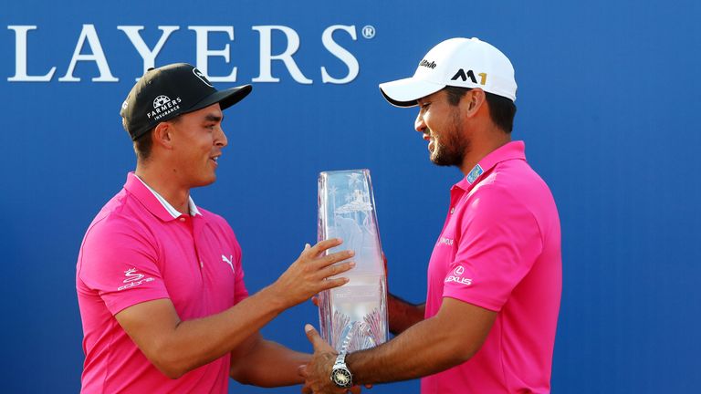  Rickie Fowler (L) of the United States presents the trophy to Jason Day of Australia after Day won the final round of THE Players championship