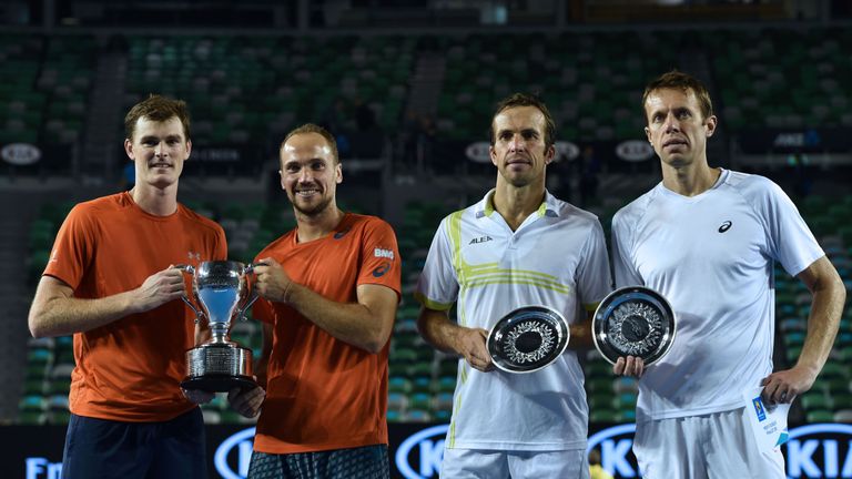 Britain's Jamie Murray (L) and Brazil's Bruno Soares (2L) pose with the trophy as they celebrate after victory in their men's doubles final match against C