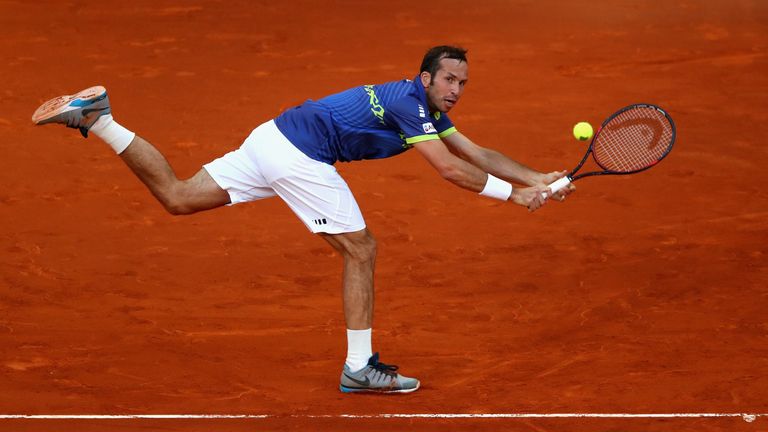 Radek Stepanek of the Czech Republic stretches to play a backhand against Andy Murray of Great Britain