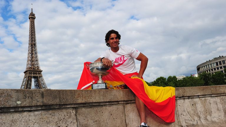 Rafael Nadal of Spain poses with the Coupe des Mousquetaires trophy in front of the Eiffel Tower after his victory against Novak D
