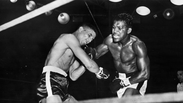 Randolph Turpin buckles under a blow from Sugar Ray Robinson