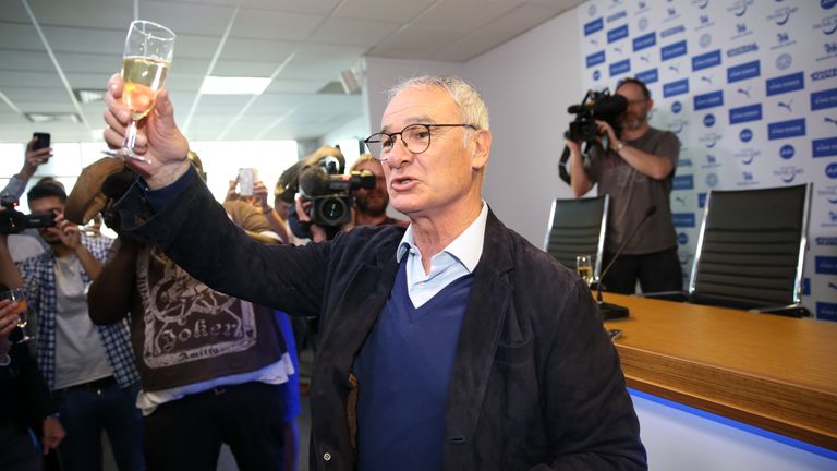 Claudio Ranieri raises a glass of champagne with the press during the Leicester City press conference 