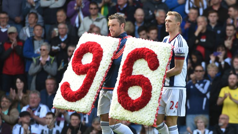 Rickie Lambert and Darren Fletcher of West Brom carry a wreath to remember the 96 victims of the Hillsborough 