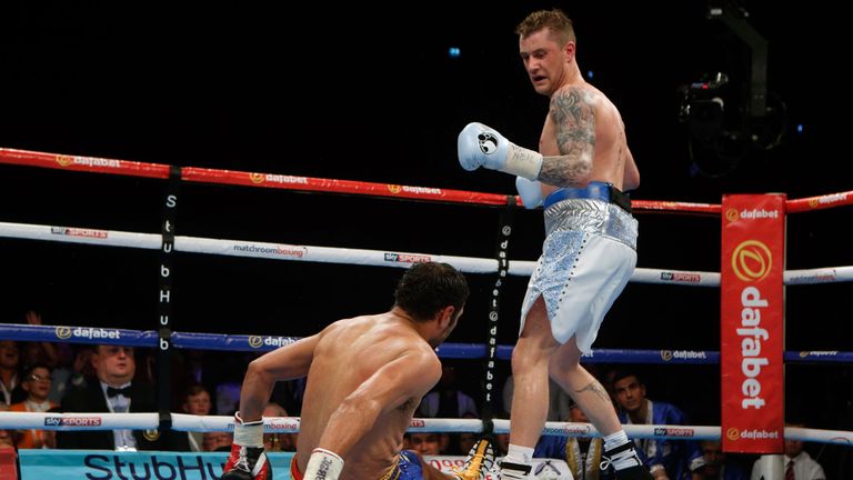 Ricky Burns knocks down Michele Di Rocco during the WBA super-lightweight world title bout at the SSE Hydro, Glasgow.