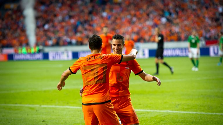 Robin van Persie celebrates with teammate Ibrahim Afellay during the Netherlands' 6-0 win over Northern Ireland in a 2012 friendly