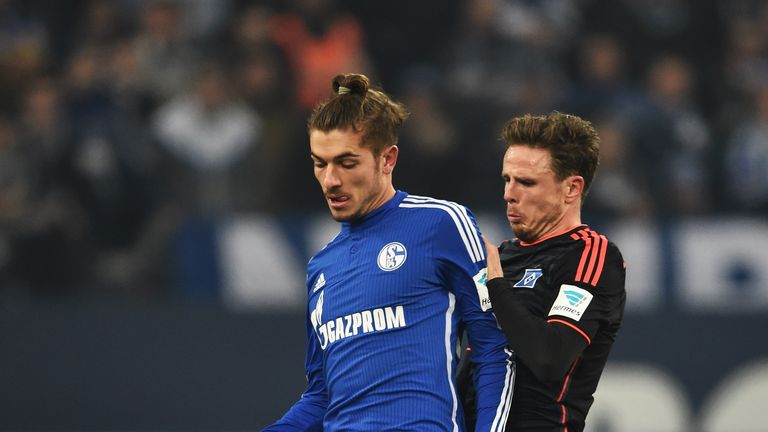 Nicolai Müller of Hamburg is challenged by Roman Neustädter of Schalke during the Bundesliga match between FC Schalke 04 and Hamburger SV