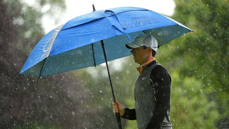 Rory McIlroy of Northern Ireland walks in the rain with an umbrella on the 15th hole during the final round of the Dubai Duty Free Irish Open