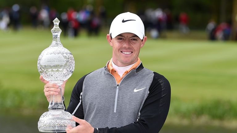 Rory McIlroy of Northern Ireland poses with the trophy