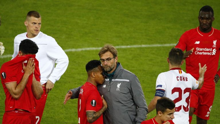 Liverpool manager Jurgen Klopp consoles his players.