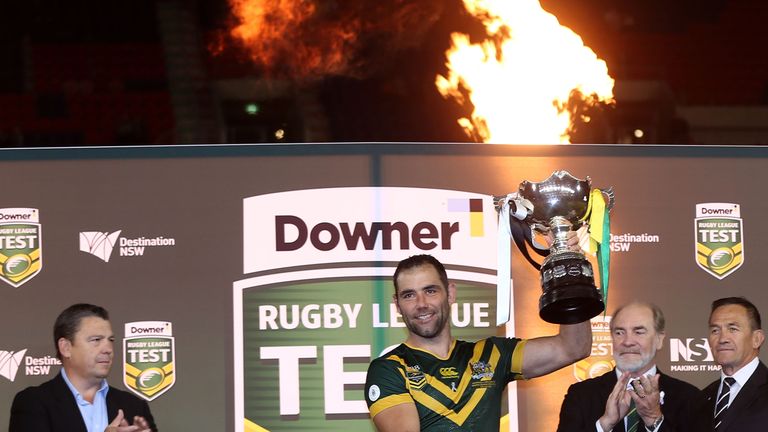 Cameron Smith of the Kangaroos holds aloft the Bill Kelly Memorial Trophy