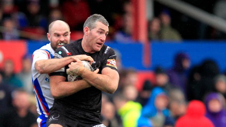 Widnes' Chris Houston is tackled by Liam Finn of Wakefield