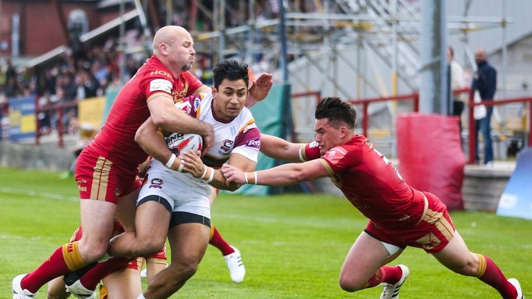 Chris Ulugia is tackled by Catalans duo Glenn Stewart (left) and Justin Horo