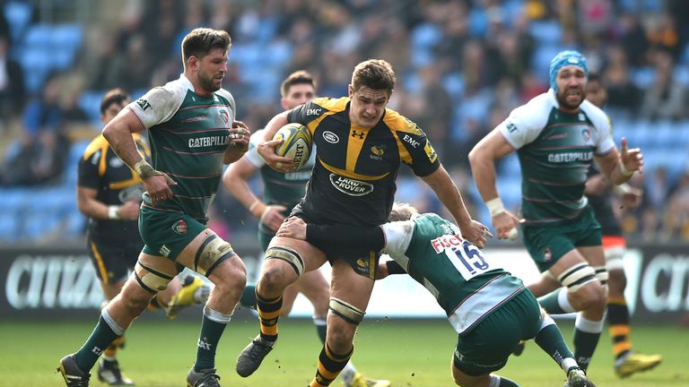 Sam Jones of Wasps is tackled by Mathew Tait of Leicester Tigers during the Aviva Premiership match between Wasps and Leicest