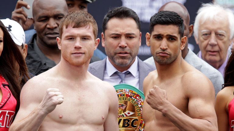 Mexican Saul 'Canelo' Alvarez (L) and British Amir Khan pose during their weigh-in on May 6, 2016 in Las Vegas