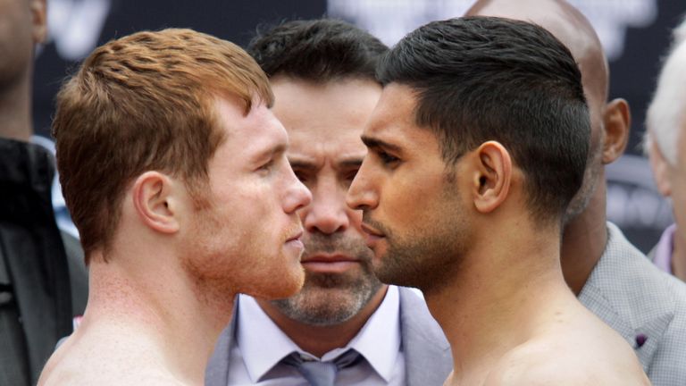 Mexican Saul 'Canelo' Alvarez (L) and British Amir Khan face off during their weigh-in on May 6, 2016 in Las Vegas