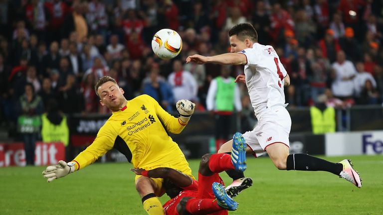 Kevin Gameiro (R) of Sevilla compete for the ball against Kolo Toure (C) and Simon Mignolet (L) of Liverpool  during the UEFA 