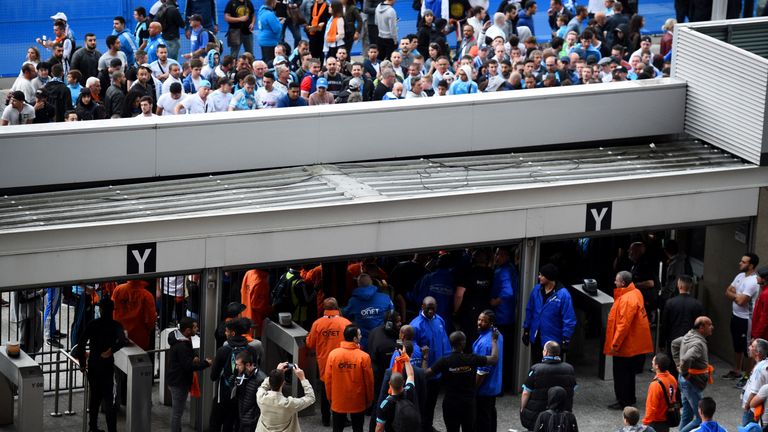 Stade de France's security staff control Marseille's supporters arriving at the entrance of the stadium prior to the the French Cup final football match be