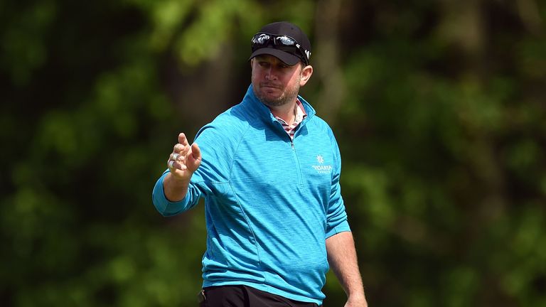 Steve Wheatcroft waves to the crowd following a birdie on the 12th hole during the first round of the Wells Fargo Championship at Quail Hollow