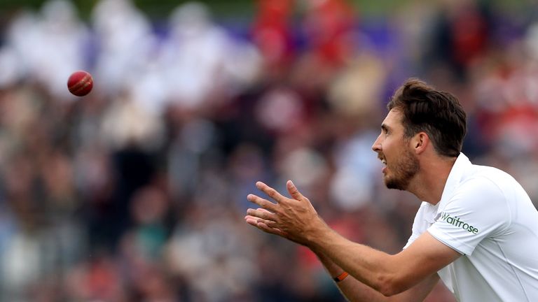 England's Steven Finn catches the ball to bowl 