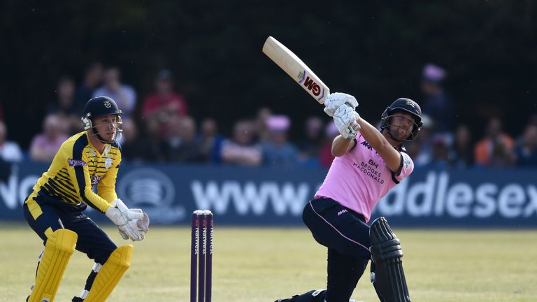 Dawid Malan of Middlesex hits a huge 6 as wicketkeeper Adam Wheater of Hampshire looks on during the NatWest T20 Blast