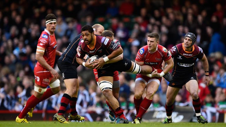 CARDIFF, WALES - APRIL 30:  Taulupe Faletau is tackled by Scott Williams of the Scarlets during the Guinness Pro 12 match between Newport Gwent Dragons and