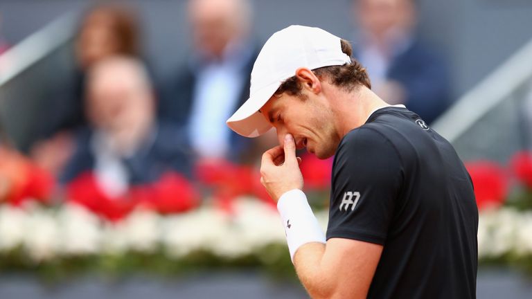 Andy Murray of Great Britain looks down in his match against Novak Djokovic of Serbia at the Madrid Open