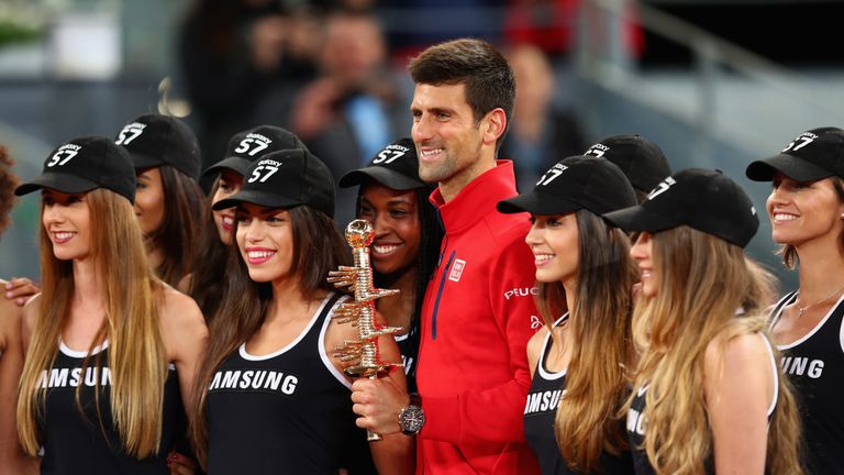 Novak Djokovic holds the winners trophy after defeating Andy Murray Madrid Open final