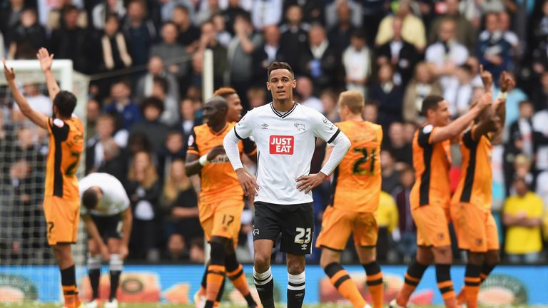 Tom Ince of Derby County looks dejected as Hull City players celebrate 