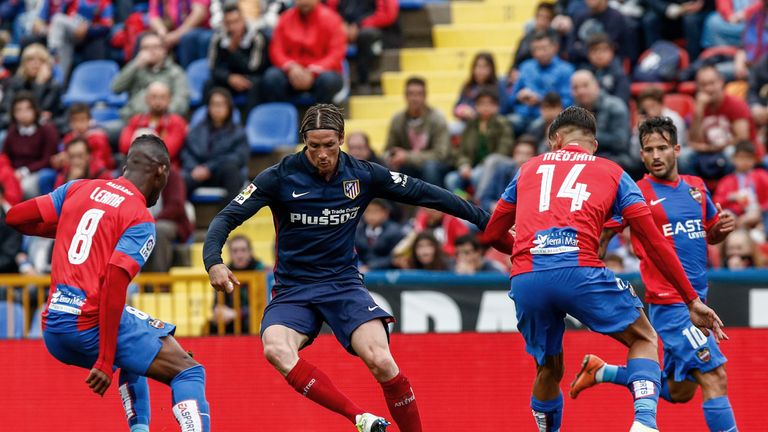 Atletico's forward Fernando Torres (2nd L) vies with Levante's French defender Carl Medjani (R) and Levante's Colombian midfielder Jefferson Lerma (L) duri