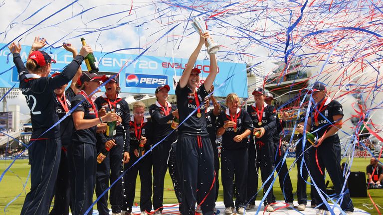 Charlotte Edwards of England lifts the trophy as her team celebrate victory after the ICC Women's World Twenty20