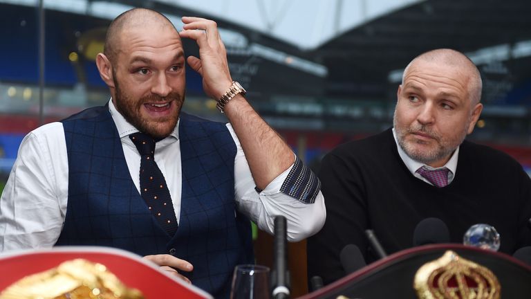 Tyson Fury (L) takes part in a press conference with his uncle and trainer Peter Fury