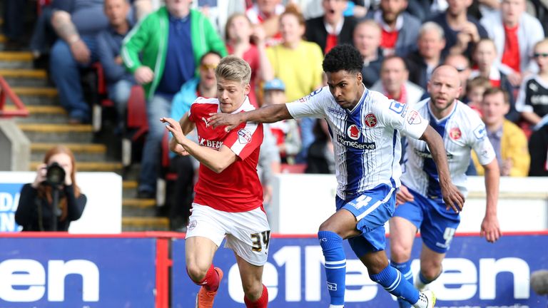 Wallsal's Rico Henry (right) and Barnsley's Lloyd Isgrove battle for the ball during the Sky Bet League One playoff, first leg match at Oakwell, Barnsley