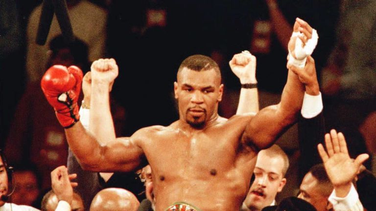 New World Boxing Council (WBC) heavyweight champion Mike Tyson is lifted into the air 