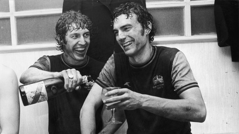 West Ham footballers Pat Holland (left) and Trevor Brooking sharing a glass of champagne after Brooking had scored twice against Eintracht Frankfurt in the