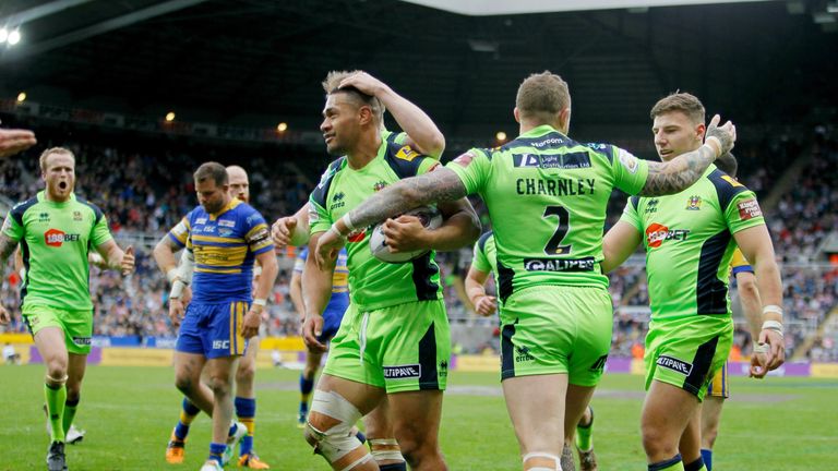 Wigan Warriors players celebrate after Willie Isa (left) scores a try against Leeds Rhinos