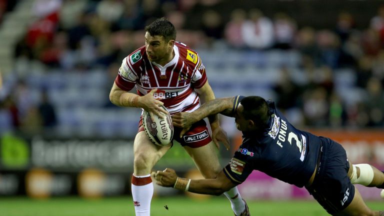 Wigan's Matty Smith is tackled during his side's defeat on Friday