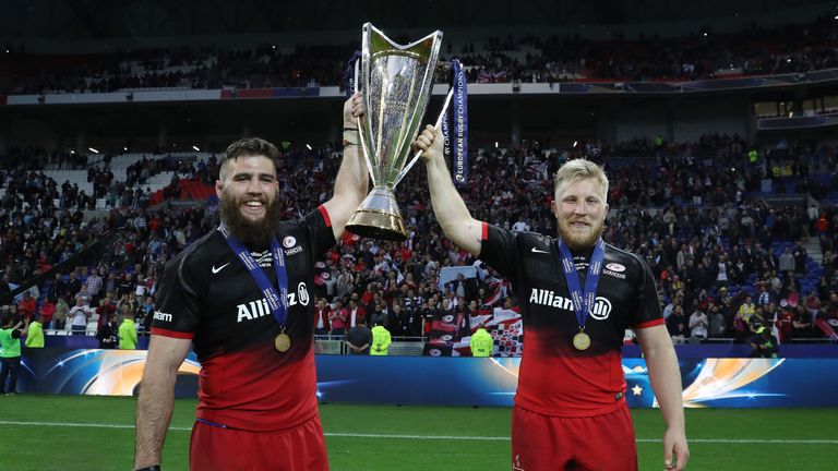 Will Fraser and Jackson Wray of Saracens celebrate with the trophy after the Champions Cup Final victory over Racing 92