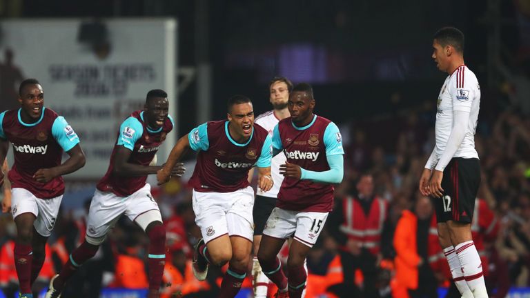 Chris Smalling of Manchester United looks dejected as Winston Reid of West Ham United celebrates as he scores their third goal 